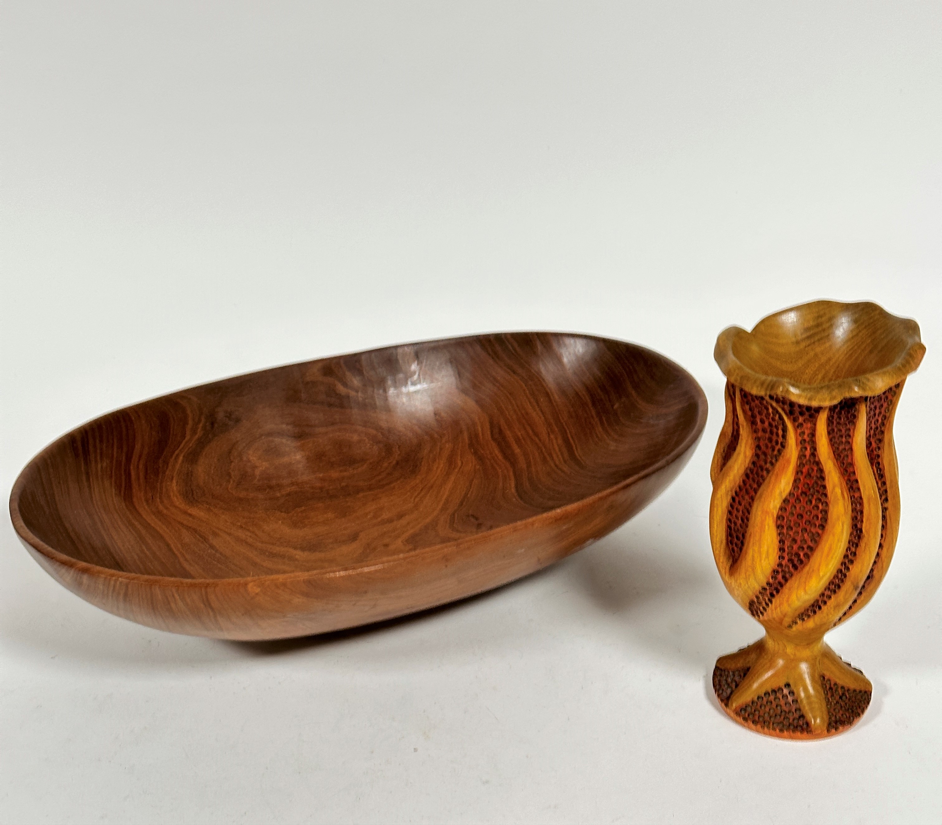 A teak mid century oval salad bowl, (h 9cm x 39cm x 24cm) and a Donnachi treen carved elm vase