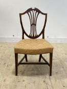 A George III mahogany chair of Hepplewhite design, shield back over upholstered seat, raised on