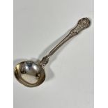 A Georgian silver shaped sauce ladle with chased rose and leaf design with fan shell chased rear