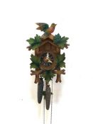 A Black Forest style eight day cuckoo clock, complete with weights and pendulum, mechanically good