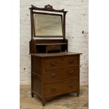 An Art Nouveau period walnut dressing chest, with swing mirror over trinket drawer and three long