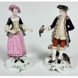 A pair of Spode Chelsea style porcelain figures of a huntsman, dog and quarry, raised on socle style