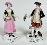 A pair of Spode Chelsea style porcelain figures of a huntsman, dog and quarry, raised on socle style