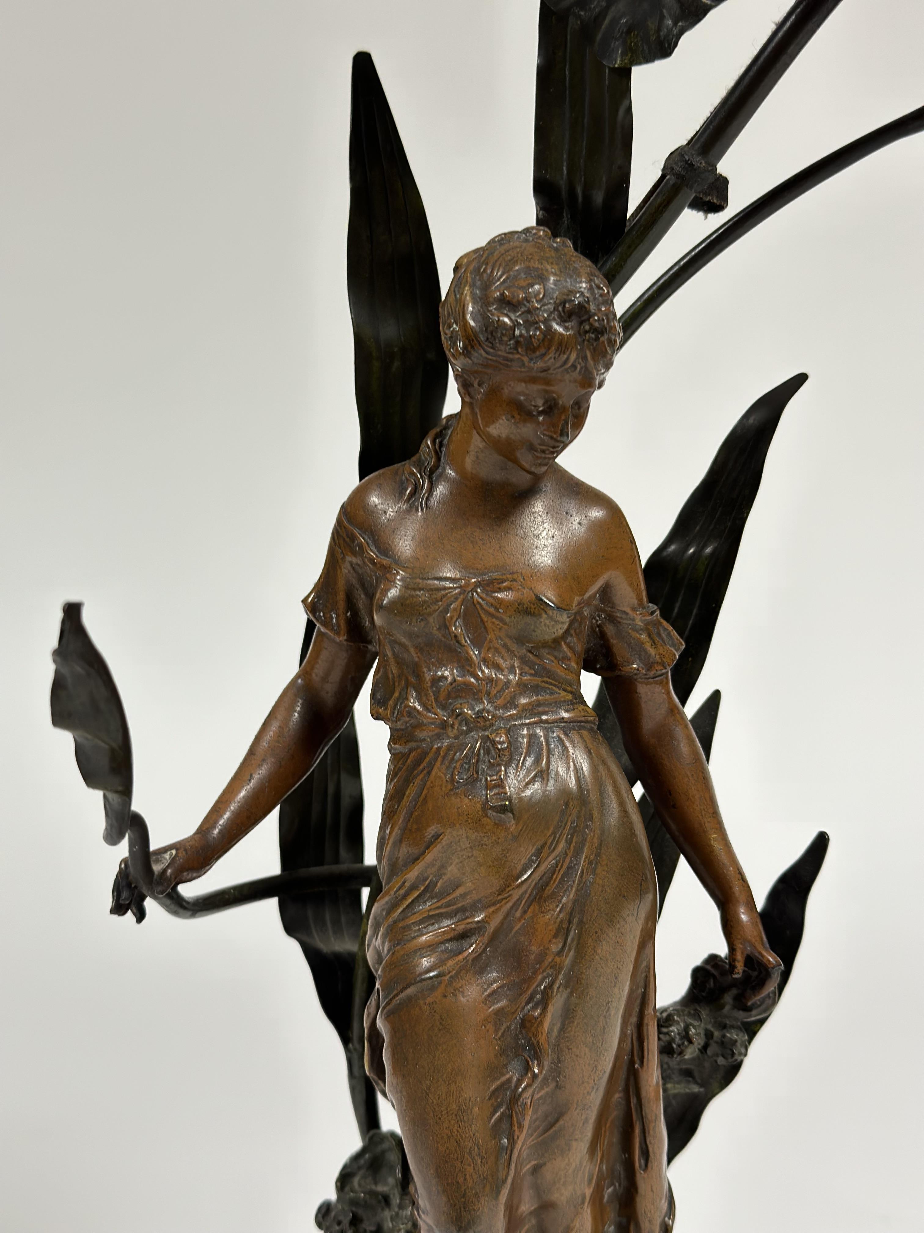 A French spelter figural lamp in the Art Nouveau taste, signed Moreau, modelled as a lady nestled - Image 2 of 3