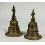 Two brass stupa, probably Indian, of characteristic design. 25cm and 21cm (2)