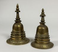 Two brass stupa, probably Indian, of characteristic design. 25cm and 21cm (2)