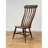 A 19th century vernacular elm side chair, the well raked comb back over shaped saddle seat, raised