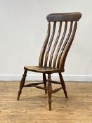 A 19th century vernacular elm side chair, the well raked comb back over shaped saddle seat, raised