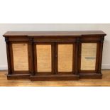A William IV rosewood breakfront side cabinet, the top with relief-carved backboard decorated with