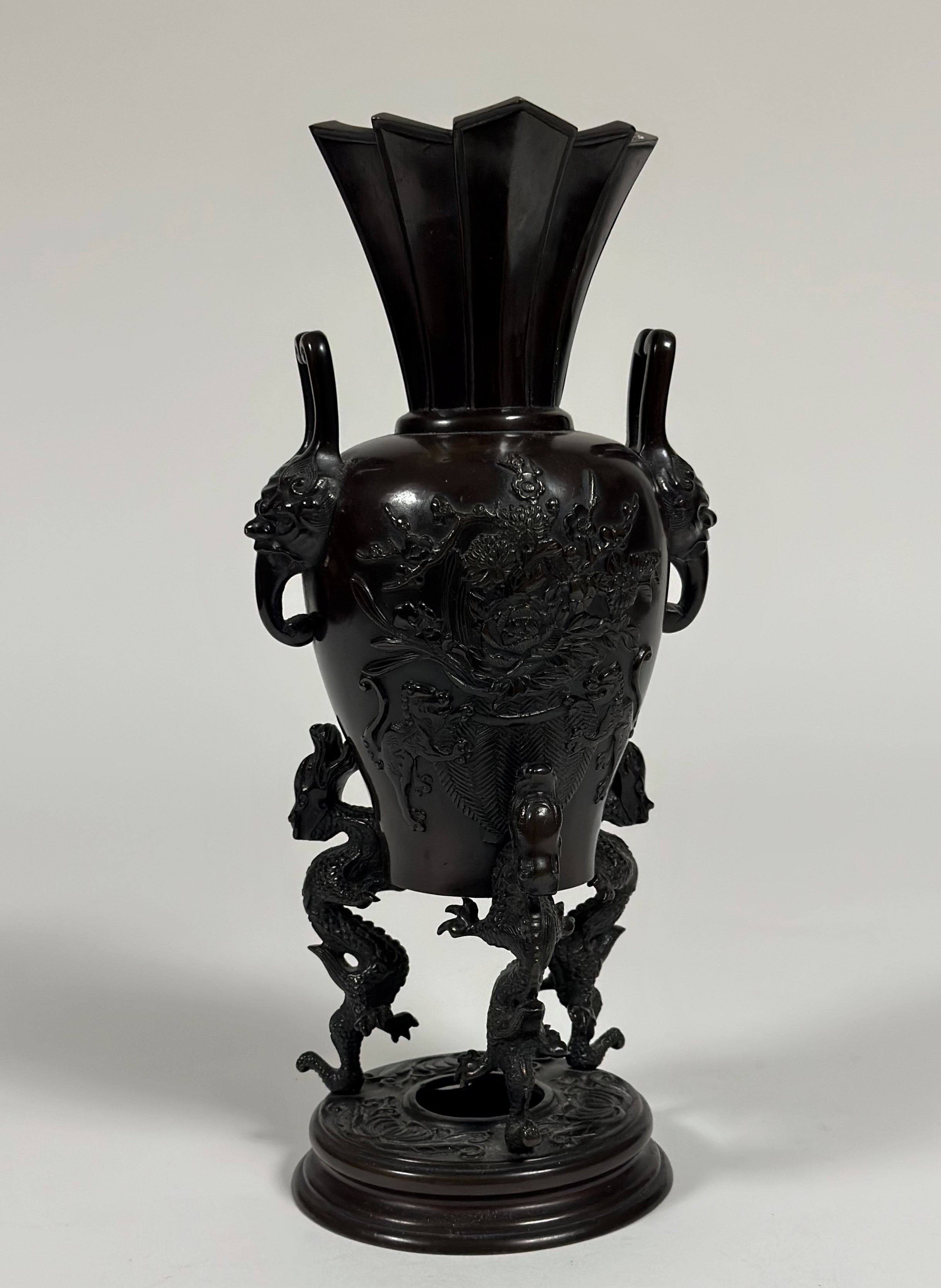 A Japanese bronze tripod censer, Meiji period, of baluster form, the body in relief with baskets