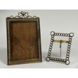Two early 20th century brass photograph frames, each with "chainlink" frame and easel back (