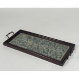 A pair of Chinese silk needlework sleeve panels mounted as a tray, c. 1920, the panels worked in