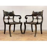 A pair of gilt and black lacquered elbow chairs of Regency design, circa 1920, the crest rail