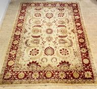 A large Ziegler type rug, hand knotted, the ivory field decorated with interlaced foliate and