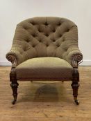 An early Victorian walnut-framed spoon back armchair, the buttoned back above a stuffed-over seat,