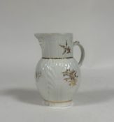 A Caughley porcelain mask jug, c. 1790, of characteristic form, with leaf-moulded body, decorated