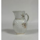 A Caughley porcelain mask jug, c. 1790, of characteristic form, with leaf-moulded body, decorated