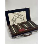 An early 20th Century optometrist's eye testing kit, the brown leather travelling case enclosing a