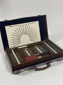 An early 20th Century optometrist's eye testing kit, the brown leather travelling case enclosing a