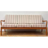 L Olsen & Son, A Danish mid century teak three seat sofa, the slatted back over sprung squab