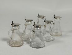 An assembled set of six silver-mounted cut-glass toddy jugs, four by S. Blanckensee & Son,