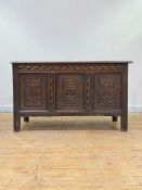 A late 18th/ early 19th century oak three panel coffer, the top opening to a plain interior fitted