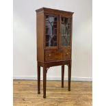 A small George III mahogany secretaire cabinet on stand, the moulded cornice above a pair of