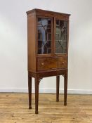 A small George III mahogany secretaire cabinet on stand, the moulded cornice above a pair of