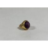 A single stone star sapphire ring, the oval cabochon stone (worn) set on a tapering band with