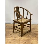A Chinese elm horseshoe back chair, late 19th/ early 20th century, the sweeping crest rail with