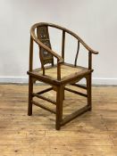 A Chinese elm horseshoe back chair, late 19th/ early 20th century, the sweeping crest rail with