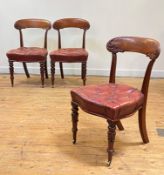 A set of three Victorian mahogany side chairs, circa 1840, the crest rail carved with scrolling