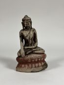 A South-East Asian painted alabaster figure of a seated Buddha, probably 19th century, modelled on a