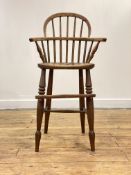 A 19th century elm and ash Windsor high chair, the double hoop and spindle back over shaped saddle