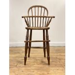 A 19th century elm and ash Windsor high chair, the double hoop and spindle back over shaped saddle