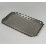 A white metal tray, early 20th century, of rectangular form, with floral trellis rim, stamped