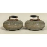 A pair of granite curling stones, with white metal collars and ebonised handles. Diameter c. 27cm