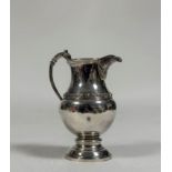 A George V silver cream jug, Davidson, Henderson & Sorley, Birmingham 1914, of baluster form, with