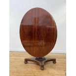 A William IV 4'6" rosewood dining table, the circular tilt top over a faceted octagonal column,