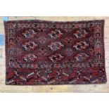 A hand knotted Turkoman bag face rug, characteristically decorated with guls. 135cm x 86cm.