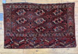 A hand knotted Turkoman bag face rug, characteristically decorated with guls. 135cm x 86cm.