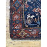 A hand knotted Persian Heriz rug, early 20th century, the deep blue abrashed field decorated