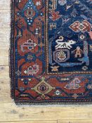 A hand knotted Persian Heriz rug, early 20th century, the deep blue abrashed field decorated