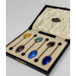 A cased set of six George V silver and enamel coffee spoons, Barker Brothers, Birmingham 1930, the