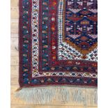 A hand knotted Caucasian rug, of all over geometric design with multiple guard stripes to border