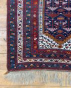 A hand knotted Caucasian rug, of all over geometric design with multiple guard stripes to border