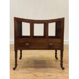 A 19th century mahogany three division Canterbury, fitted with a drawer, raised on slender ring