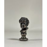 A 19th century silvered bronze desk seal, model as the bust of a Bacchic child, his head crowned