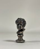 A 19th century silvered bronze desk seal, model as the bust of a Bacchic child, his head crowned