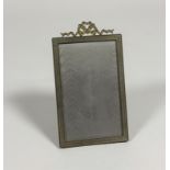 An Edwardian gilt-metal photograph frame, the rectangular aperture within a ribbon-bound reeded